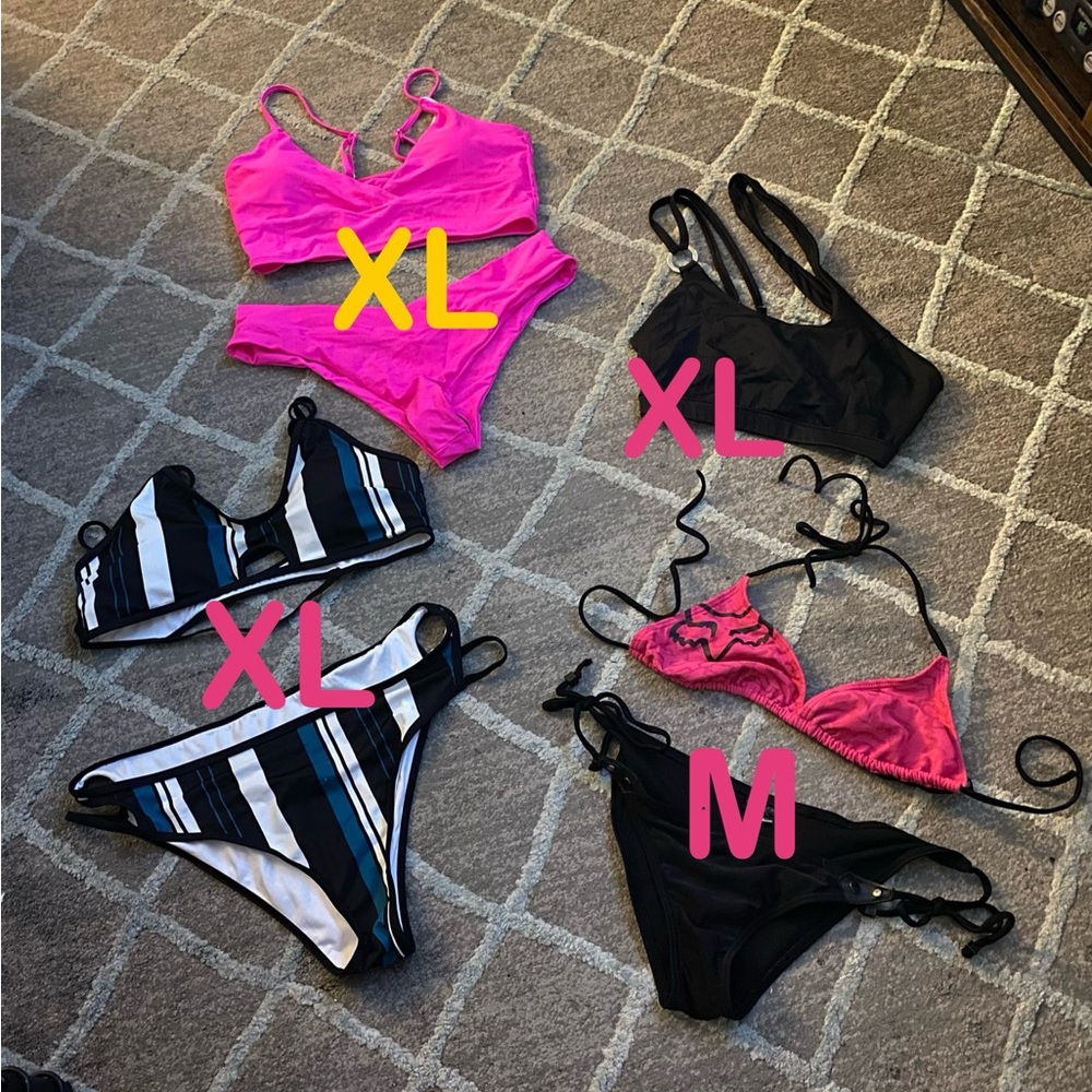 Three bikinis, one black top. All brand new, never worn.